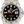 A Rolex Explorer 2 watch with a stainless steel bracelet, black dial, black bezel with white indices, and an orange GMT hand.